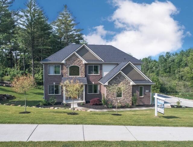 270 Fairway View Dr, Oxford, MI 48371 - craftsman-style house featuring a front yard and stone siding