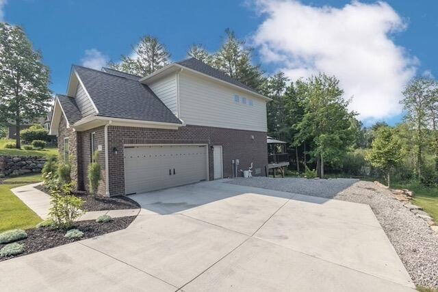 270 Fairway View Dr, Oxford, MI 48371 - view of home's exterior featuring brick siding, driveway, a garage, and a shingled roof