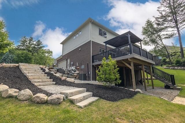 270 Fairway View Dr, Oxford, MI 48371 - rear view of property featuring stairway, a deck, and a lawn
