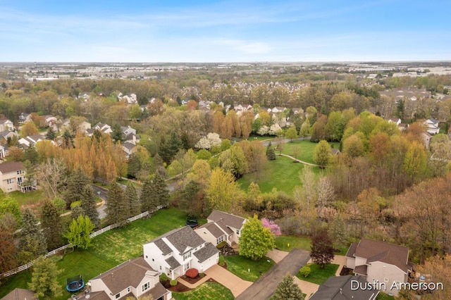 aerial view of property and surrounding area featuring nearby suburban area