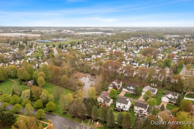 aerial view of property and surrounding area with nearby suburban area