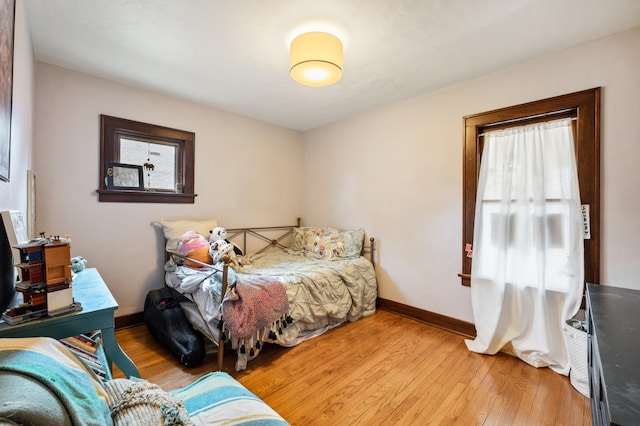 bedroom featuring light wood-type flooring and baseboards