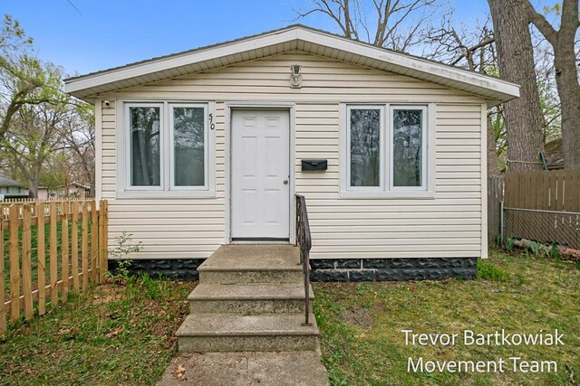 view of front of house featuring fence