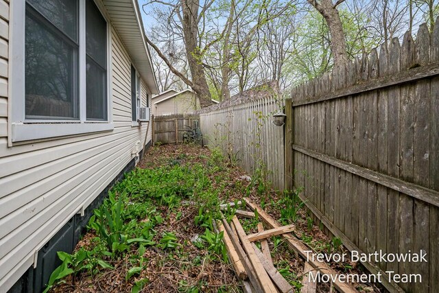 view of yard with a fenced backyard and cooling unit