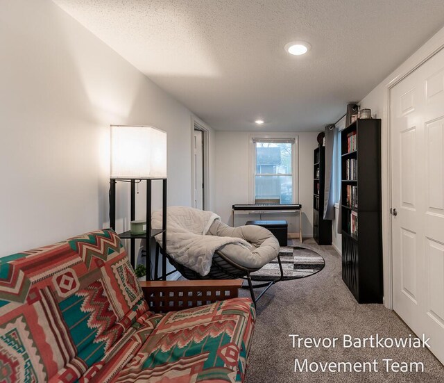 sitting room featuring recessed lighting, carpet flooring, and a textured ceiling