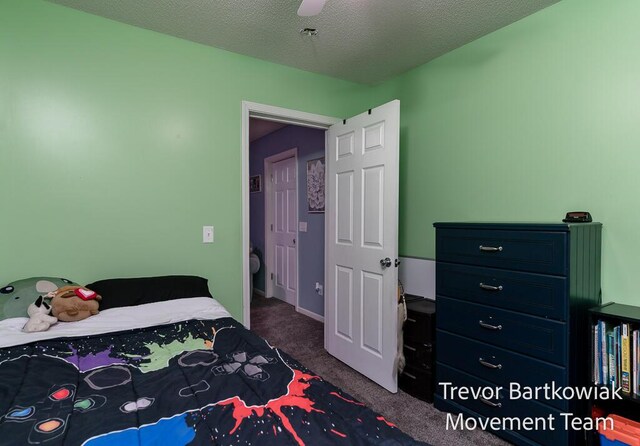 carpeted bedroom featuring a ceiling fan and a textured ceiling