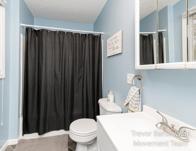 full bathroom with toilet, a textured ceiling, a shower with shower curtain, and vanity
