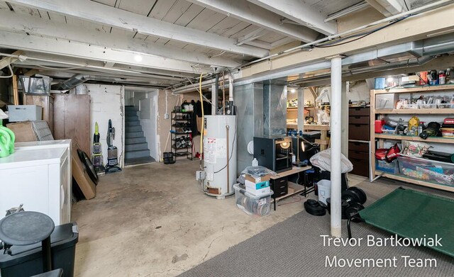 unfinished basement with water heater, stairs, and independent washer and dryer
