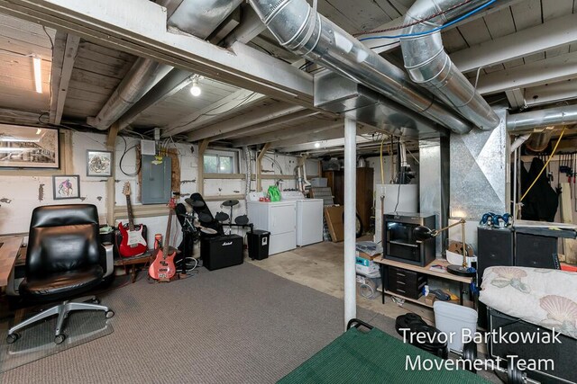 basement with washing machine and clothes dryer and electric panel
