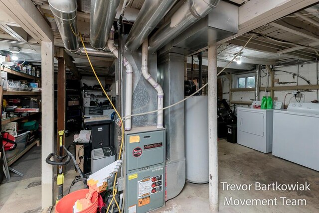 utility room featuring independent washer and dryer and gas water heater