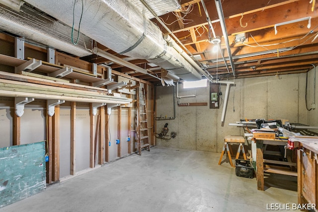 unfinished basement featuring a workshop area