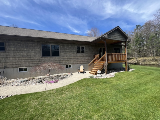 6425 S Taylor Rd, Branch, MI 49402 - view of front of house featuring stairway, a deck, a shingled roof, and a front yard