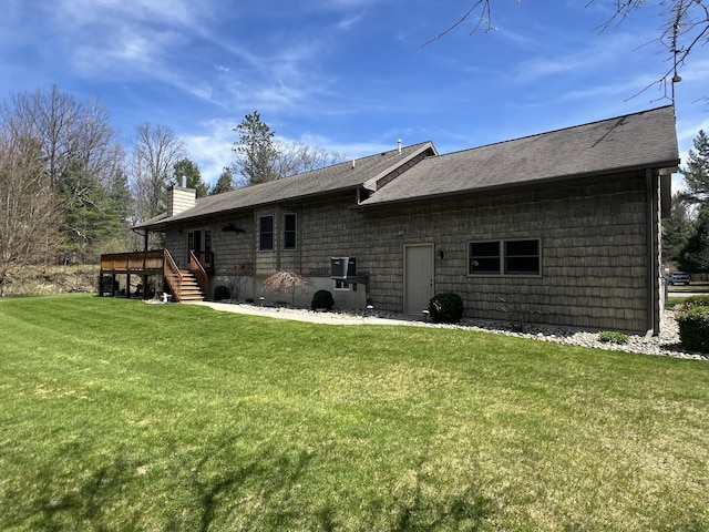 6425 S Taylor Rd, Branch, MI 49402 - back of property featuring a deck, a chimney, a shingled roof, a lawn, and stairway