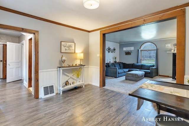 12978 Mason Dr, Grant, MI 49327 - living room with crown molding, a wainscoted wall, wood finished floors, and visible vents