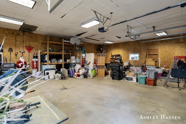 12978 Mason Dr, Grant, MI 49327 - garage with a garage door opener and a workshop area