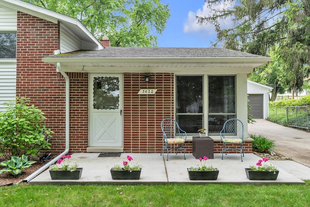 3622 Cushing Ct, Dexter, MI 48130 - property entrance with brick siding, a chimney, and driveway