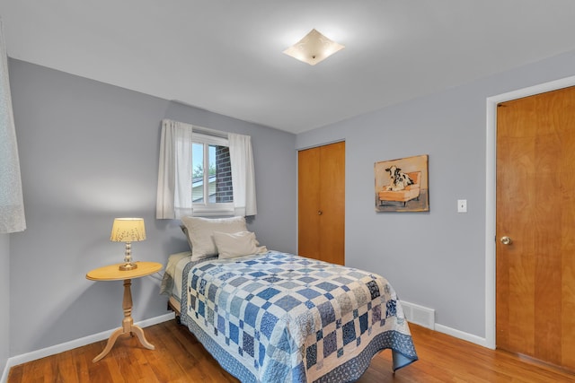 3622 Cushing Ct, Dexter, MI 48130 - bedroom featuring baseboards, wood finished floors, and a closet