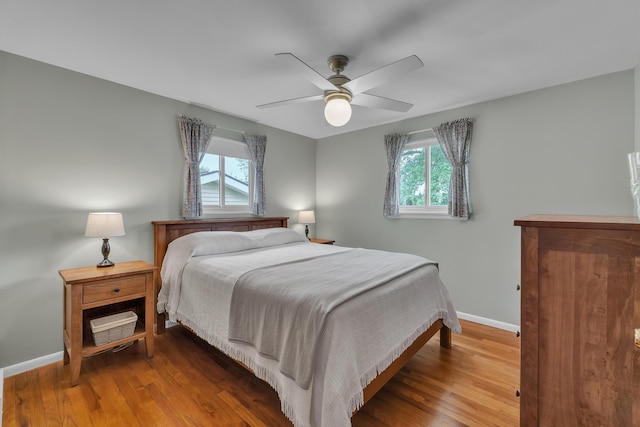 3622 Cushing Ct, Dexter, MI 48130 - bedroom with multiple windows, baseboards, and wood finished floors