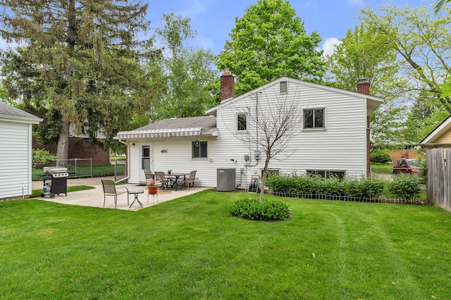 3622 Cushing Ct, Dexter, MI 48130 - rear view of house with a chimney, central AC, and a patio