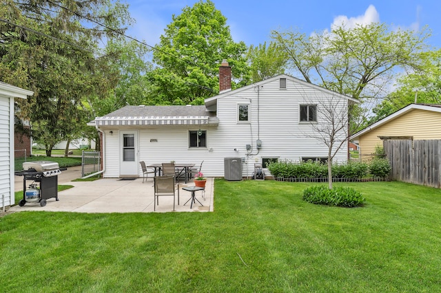 3622 Cushing Ct, Dexter, MI 48130 - rear view of house featuring a patio, a chimney, and a shingled roof