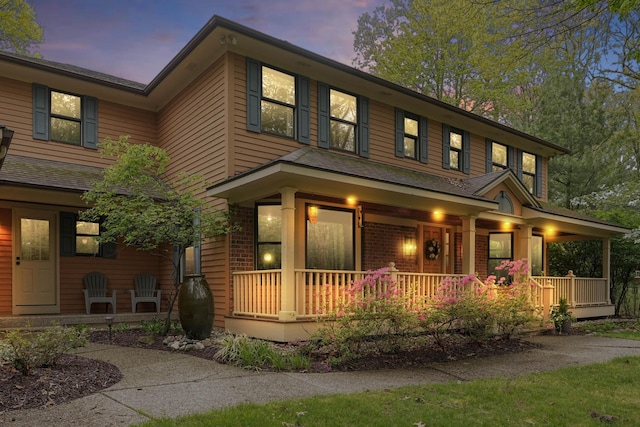 326 Greentree Ln NE, Ada, MI 49301 - view of front of property with a porch and brick siding