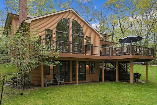 326 Greentree Ln NE, Ada, MI 49301 - rear view of house with a wooden deck, a yard, a patio, and a chimney