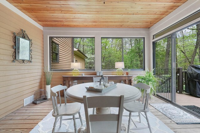 326 Greentree Ln NE, Ada, MI 49301 - sunroom / solarium with wood ceiling, hardwood / wood-style floors, wood walls, and a deck