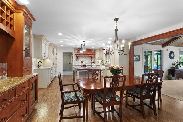 326 Greentree Ln NE, Ada, MI 49301 - dining area featuring recessed lighting, wood finished floors, a chandelier, and beam ceiling