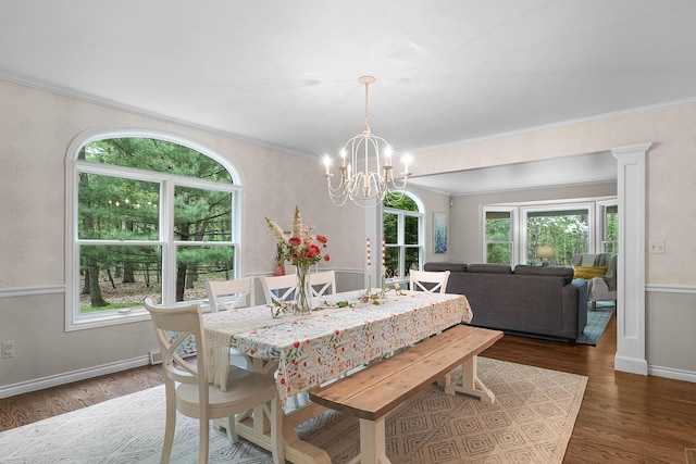 326 Greentree Ln NE, Ada, MI 49301 - dining room featuring healthy amount of natural light, wood finished floors, a chandelier, ornamental molding, and baseboards