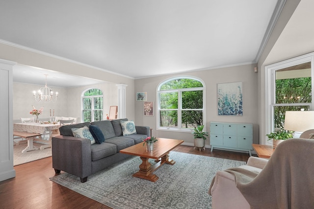 326 Greentree Ln NE, Ada, MI 49301 - living room with wood finished floors, plenty of natural light, a chandelier, and ornamental molding