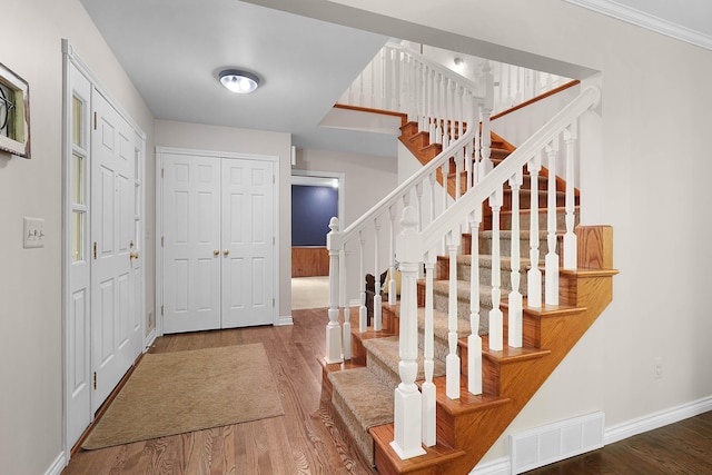 326 Greentree Ln NE, Ada, MI 49301 - entryway featuring wood finished floors, stairway, and baseboards