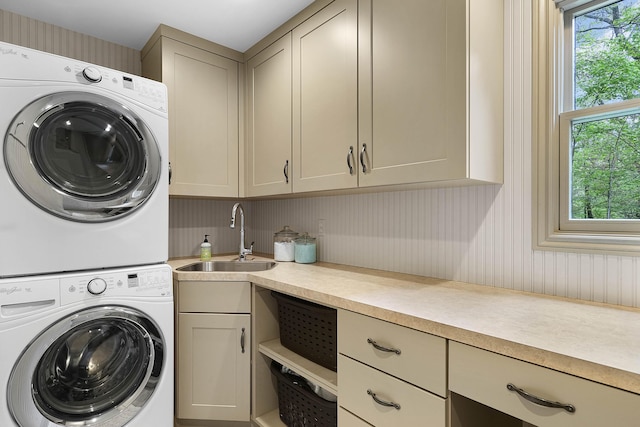 326 Greentree Ln NE, Ada, MI 49301 - laundry room featuring stacked washing machine and dryer and cabinet space