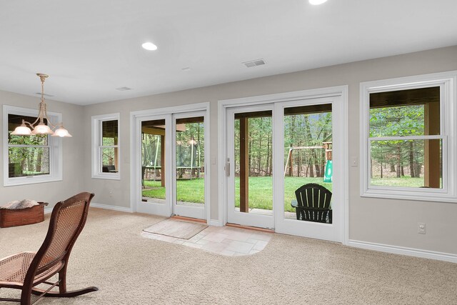 326 Greentree Ln NE, Ada, MI 49301 - doorway featuring light colored carpet, baseboards, recessed lighting, and a chandelier