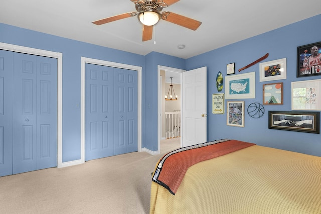 326 Greentree Ln NE, Ada, MI 49301 - carpeted bedroom with multiple closets, baseboards, and ceiling fan