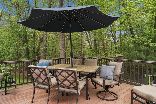 326 Greentree Ln NE, Ada, MI 49301 - wooden terrace featuring outdoor dining area and a forest view