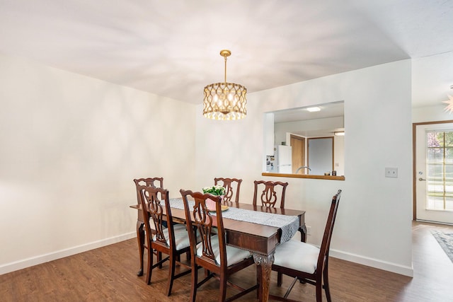 250 Appletree Ln, Holland, MI 49423 - dining room featuring a notable chandelier, baseboards, and wood finished floors