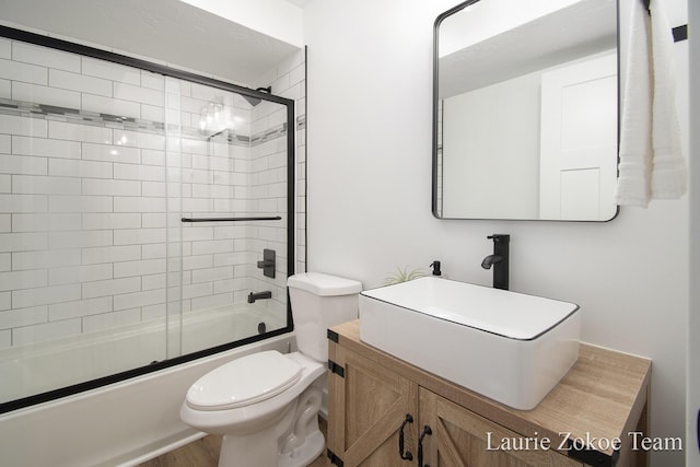 1791 Gloryfield Dr, Byron Center, MI 49315 - full bathroom featuring toilet, bath / shower combo with glass door, vanity, and wood finished floors