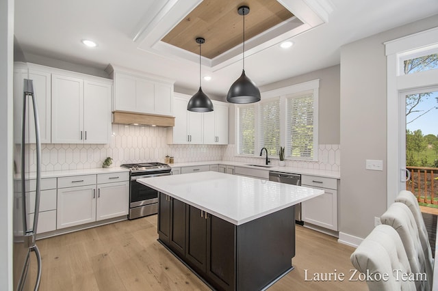 1791 Gloryfield Dr, Byron Center, MI 49315 - kitchen with stainless steel appliances, a sink, light wood-type flooring, light countertops, and white cabinetry