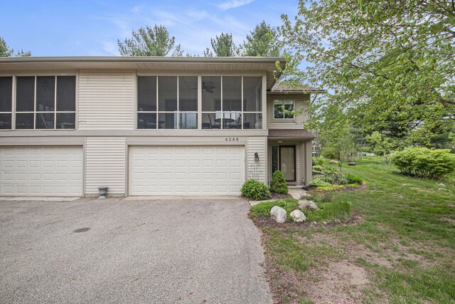 4289 Millpond Dr NE, Rockford, MI 49341 - view of front of property featuring driveway and a sunroom