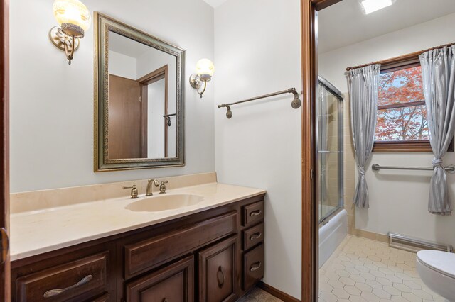 416 Barberry Ave, Portage, MI 49002 - full bath with tile patterned flooring, vanity, toilet, enclosed tub / shower combo, and visible vents
