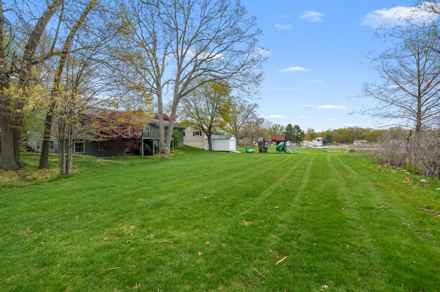 416 Barberry Ave, Portage, MI 49002 - view of yard featuring a playground, an outbuilding, and a storage shed