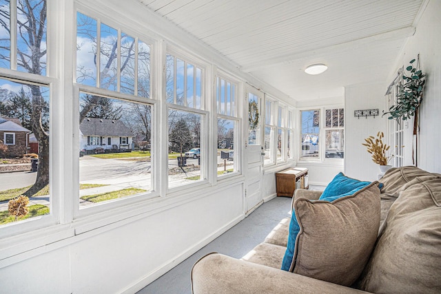 sunroom / solarium featuring carpet floors and baseboards