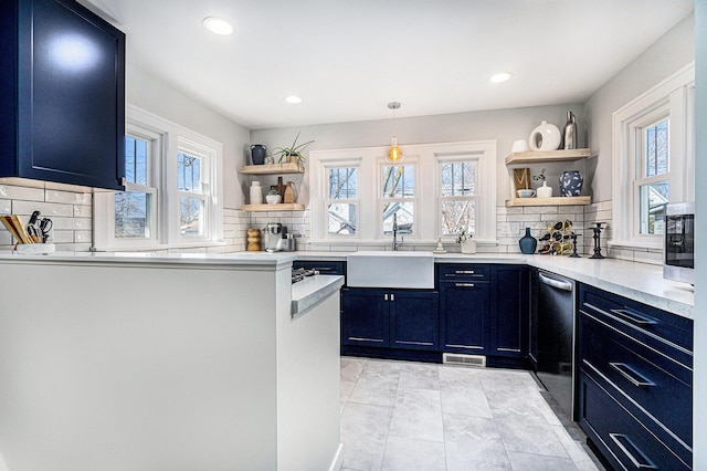 kitchen with a sink, decorative backsplash, open shelves, and blue cabinetry