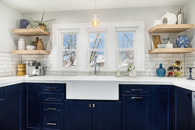 bar featuring decorative light fixtures, decorative backsplash, and a sink