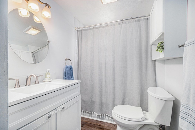 bathroom featuring vanity, a shower with shower curtain, wood finished floors, and toilet