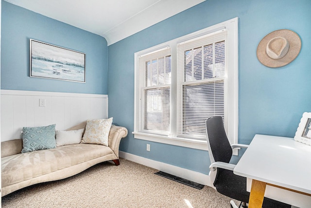 carpeted office featuring visible vents and baseboards