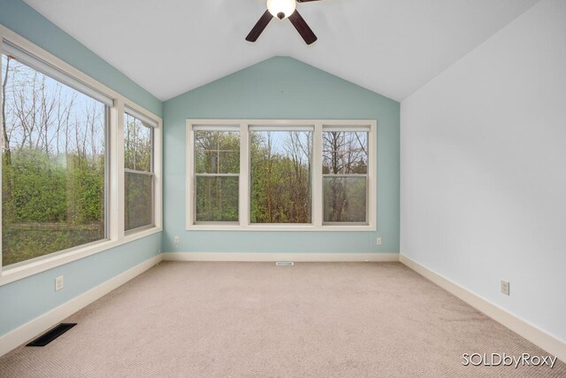 unfurnished room with ceiling fan, visible vents, plenty of natural light, and lofted ceiling