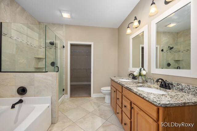 bathroom featuring a sink, a bath, and a stall shower
