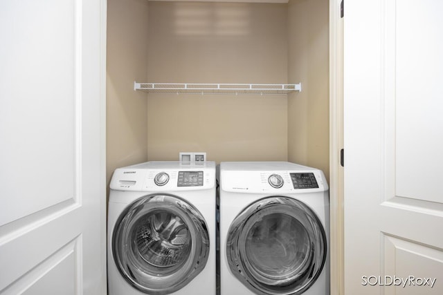 washroom with laundry area and washer and dryer