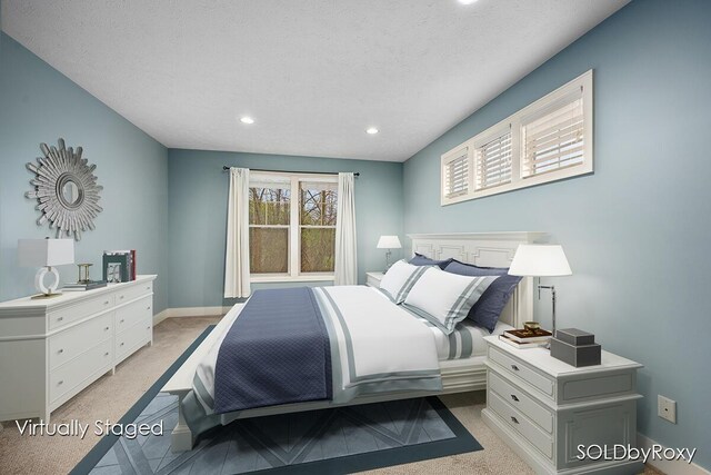 bedroom featuring baseboards, recessed lighting, a textured ceiling, and light colored carpet